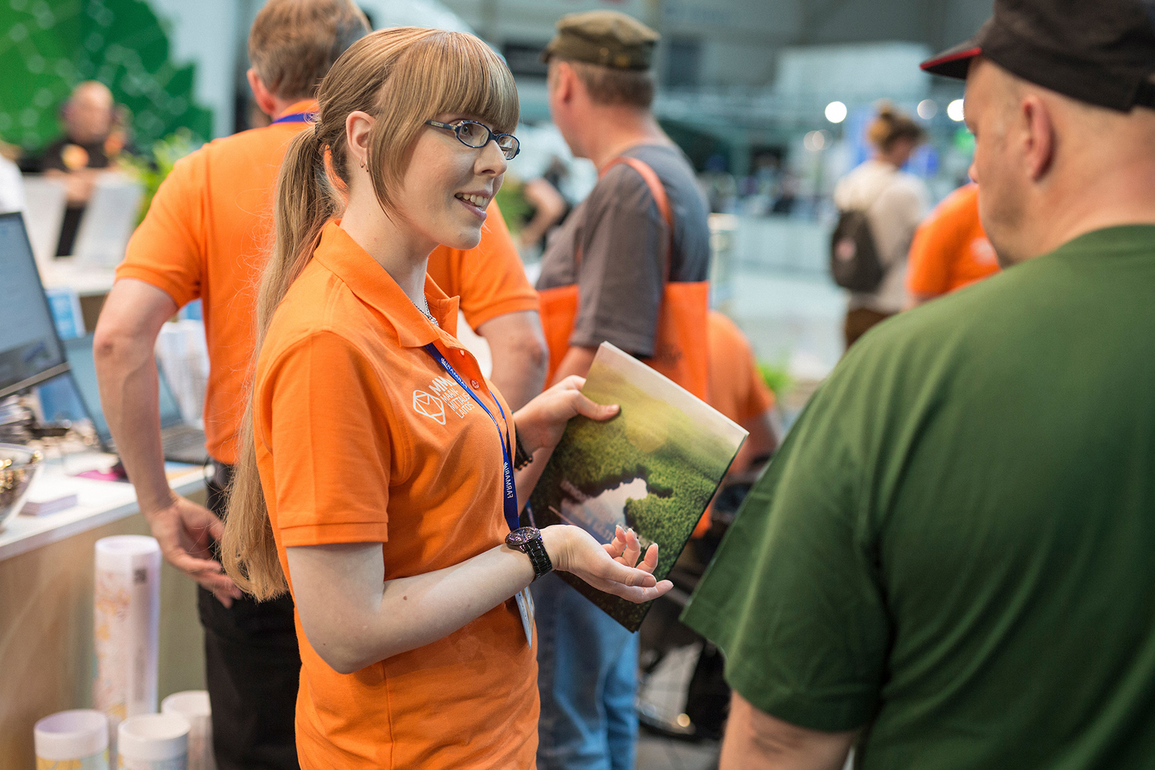 An NLS employee meeting people at an event.