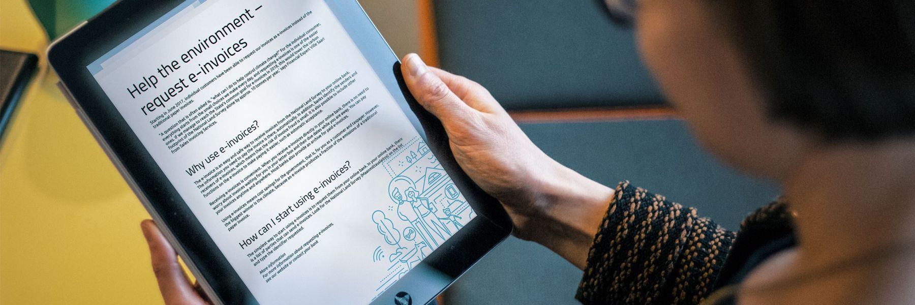 A woman reads an e-invoice with a tablet