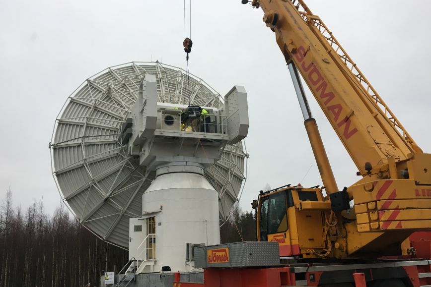 The receiver is being lifted to the telescope with a crane.