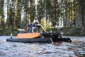 A close-up of a small boat equipped with research instruments on a river.