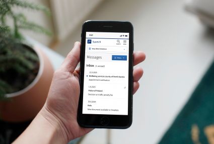The Suomi.fi Application on the screen of a mobile phone, with messages from the North Karelia Wellbeing Services County, the Police and Kela in the inbox